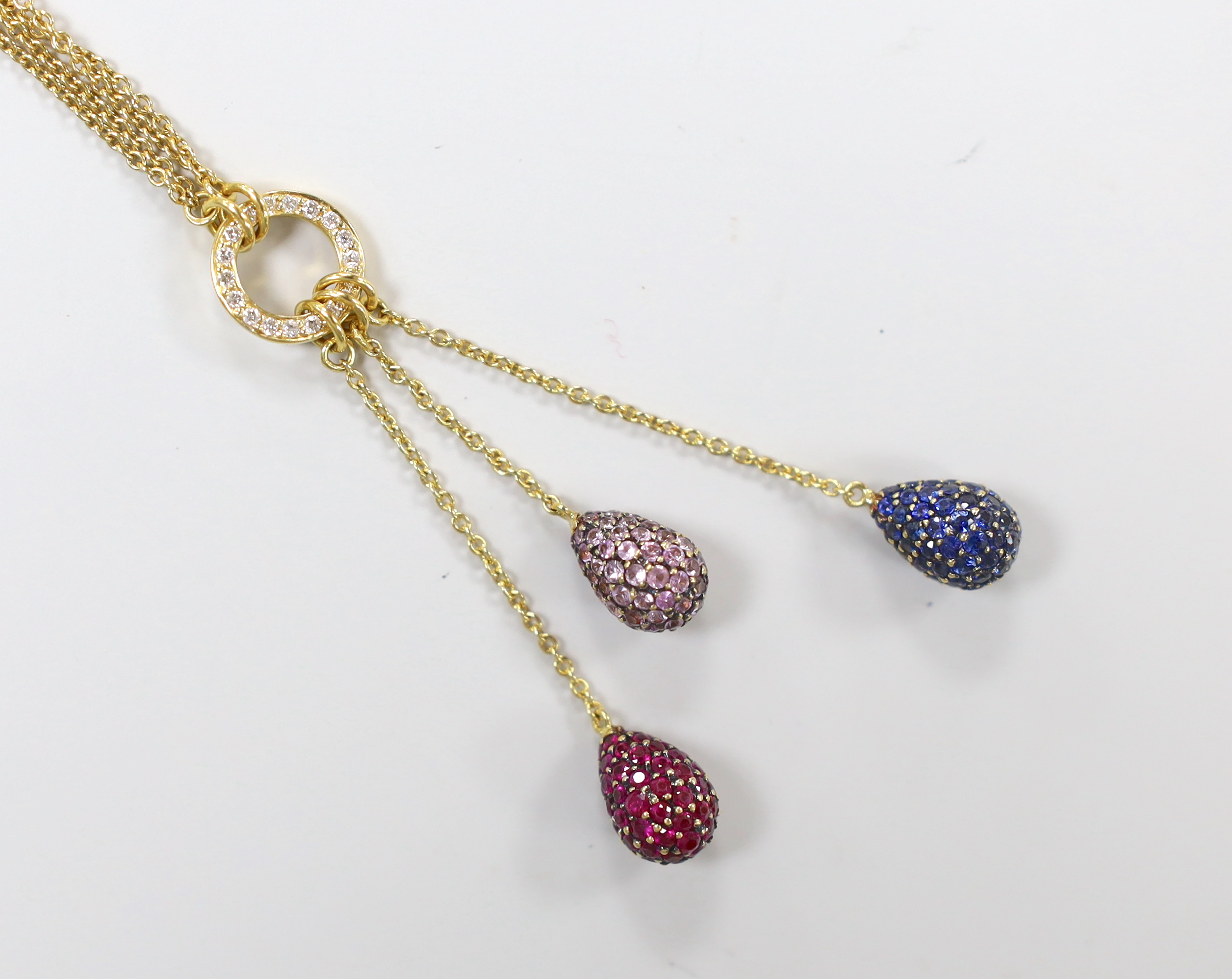 A modern 750 yellow metal, diamond chip and three colour gem pave set triple pear shaped drop pendant necklace, 51cm, gross weight 10.9 grams.